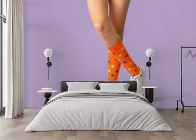 Legs of young woman in socks and shoes on color background Wall mural