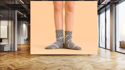 Legs of young woman in socks on color background Wall mural