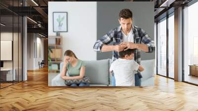 Little boy hugging his father who is taking off wedding ring. Concept of divorce Wall mural