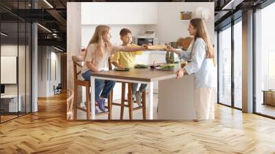 Little children and their mother making toasts with cheese in kitchen Wall mural