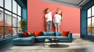 Little children measuring height near wall Wall mural