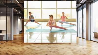 Little children practicing yoga indoors Wall mural