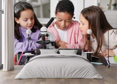 Little children with microscope studying Chemistry in science classroom Wall mural