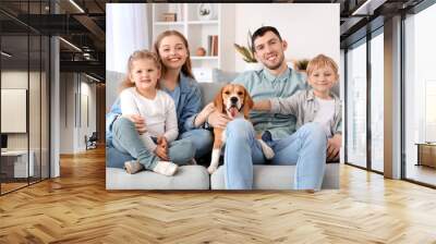 Little children with their parents and Beagle dog sitting on sofa at home Wall mural