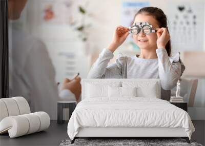 Little girl undergoing eye test in clinic Wall mural