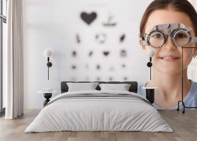 Little girl undergoing eye test in clinic Wall mural