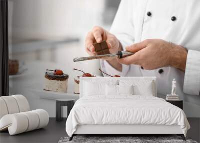 male confectioner decorating tasty dessert in kitchen, closeup Wall mural