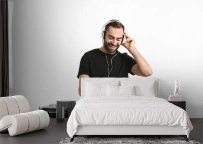 Male DJ playing music on white background Wall mural