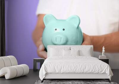 Male hands with piggy bank. Money savings concept Wall mural