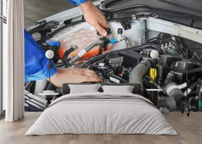 Male mechanic working in car service center Wall mural