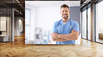 Male nurse with stethoscope in clinic Wall mural