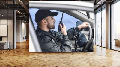 male police officer driving car Wall mural