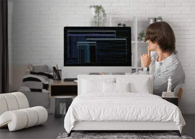 Male programmer sitting at workplace with modern computer in office Wall mural