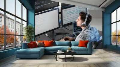 Male programmer working in office Wall mural