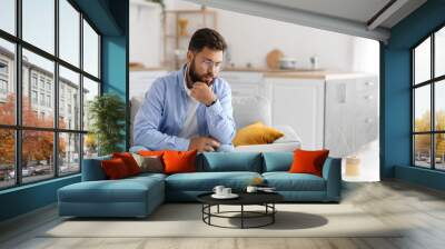 Male psychologist with laptop video chatting with patient at home Wall mural