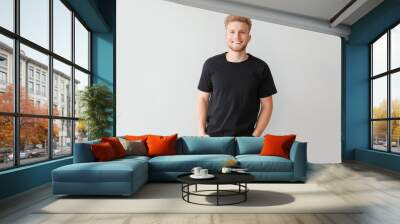 Man in stylish t-shirt on light background Wall mural