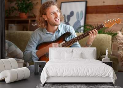 Man playing modern guitar at home Wall mural