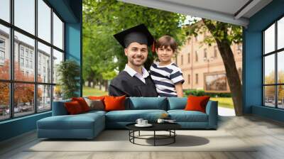 Man with his little son on graduation day Wall mural