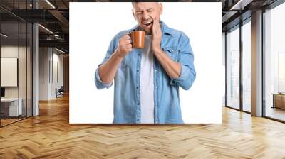 Man with sensitive teeth and hot coffee on white background Wall mural