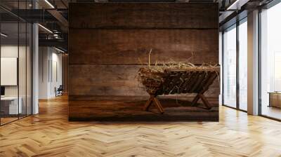 Manger with hay on wooden background Wall mural