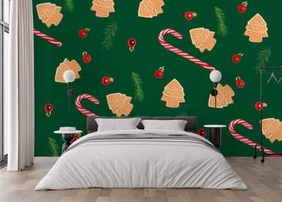 Many gingerbread cookies, candy canes and Christmas decor on green background. Pattern for design Wall mural