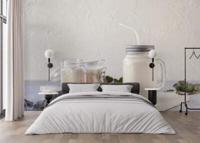 Mason jar of healthy rice milk on table Wall mural