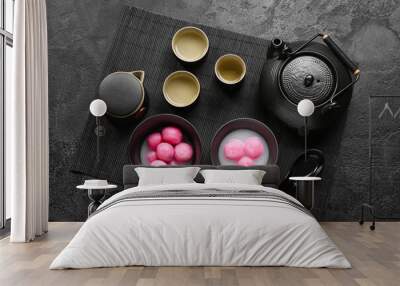 Mat with bowls of tangyuan, cups and teapot on dark background. Dongzhi Festival Wall mural