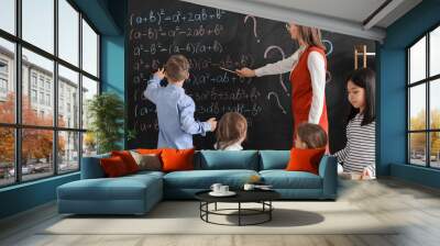 Maths teacher conducting lesson in classroom Wall mural