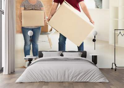 Mature couple with moving boxes at new home Wall mural