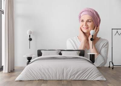 Mature woman after chemotherapy on light background Wall mural