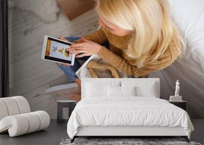 Mature woman with tablet computer and new shoes shopping online in bedroom, closeup Wall mural