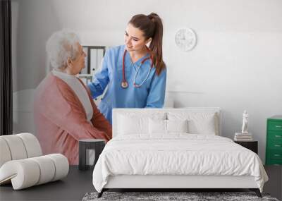 Medical worker with senior woman in nursing home Wall mural