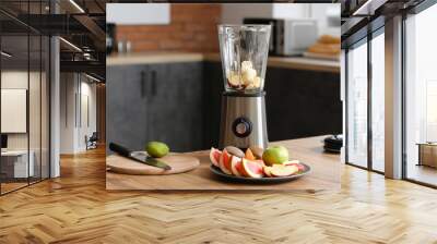 Modern blender with fresh fruits and cutting board on table in kitchen Wall mural