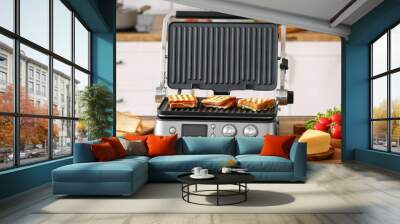 Modern electric grill with delicious sandwiches on kitchen counter Wall mural