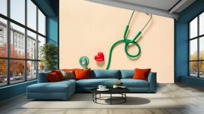 Modern stethoscope and heart on color background Wall mural