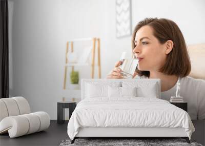 Morning of beautiful young woman drinking water in bedroom Wall mural