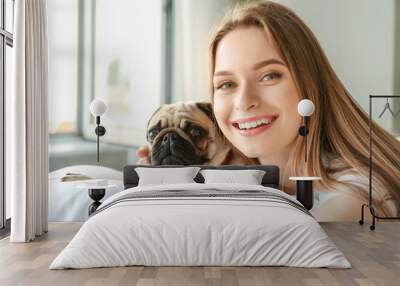 Morning of beautiful young woman with cute pug dog in bedroom Wall mural