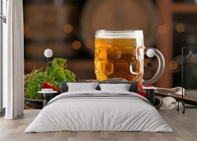 Mug of delicious beer with grilled steak and sauce on table Wall mural