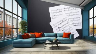 Music sheets and earphones on dark background Wall mural