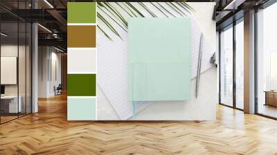 Notebooks with photo camera and pen on white background. Different color patterns Wall mural