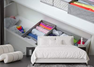 Open drawer with clean clothes in closet Wall mural