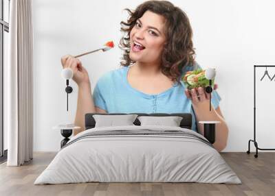 Overweight woman with bowl of salad on white background. Weight loss concept Wall mural