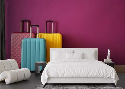 Packed suitcases near color wall Wall mural