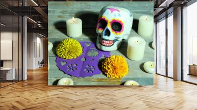 Painted skull and glowing candles on wooden background. Celebration of Mexico's Day of the Dead (El Dia de Muertos) Wall mural