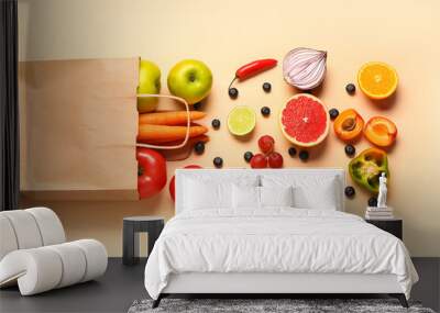 Paper bag with different fresh fruits and vegetables on orange background Wall mural