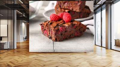 Piece of raspberry chocolate brownie on grey tile table Wall mural