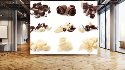 Pieces of different chocolate with curls on white background Wall mural