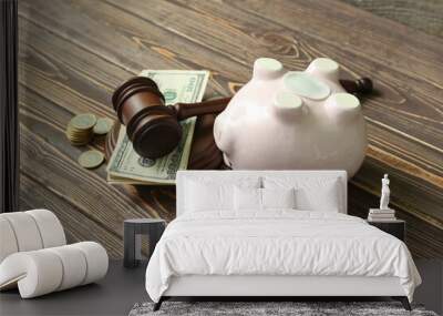 Piggy bank with judge gavel and money on brown wooden background. Concept of bankruptcy Wall mural