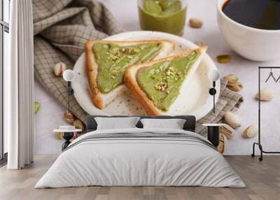 Plate and bread pieces with tasty pistachio paste on light background Wall mural