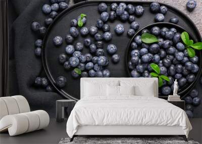 Plate and tray with sweet fresh blueberries on grey background Wall mural